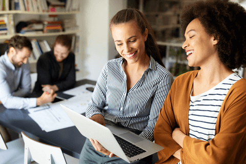 Ladies looking at laptop on local Sage Intacct partner section