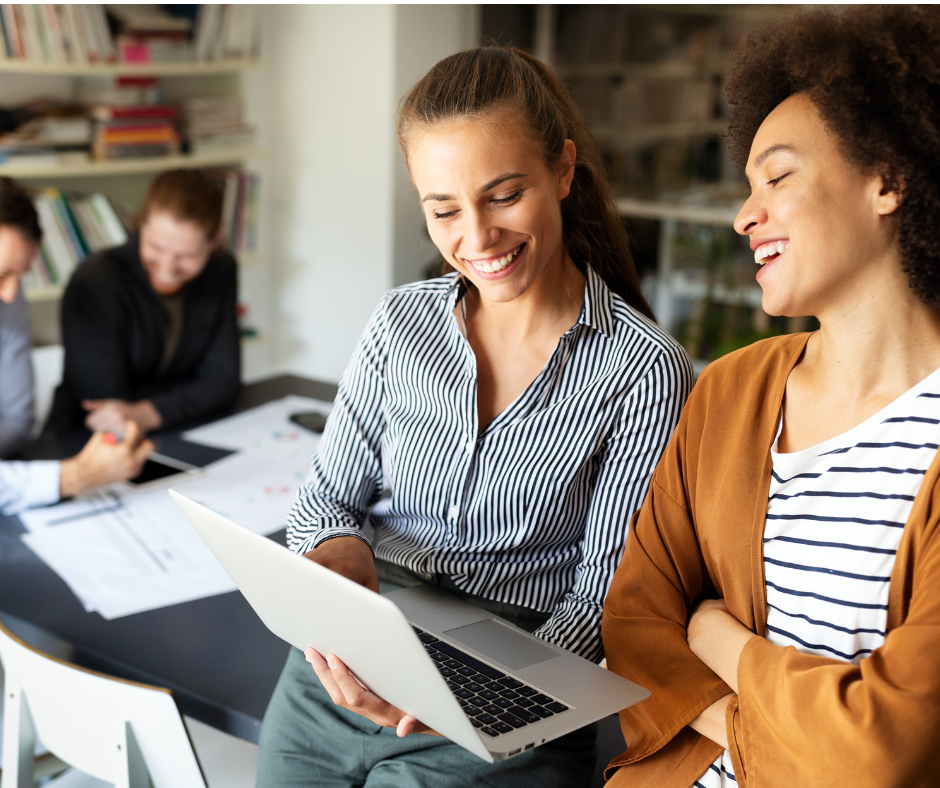 2 ladies looking at a laptop on Sage Intacct article page - 7 steps to implementing new finance software