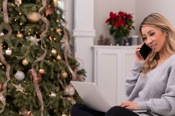 Lady next to Christmas tree using laptop on CPiO blog page