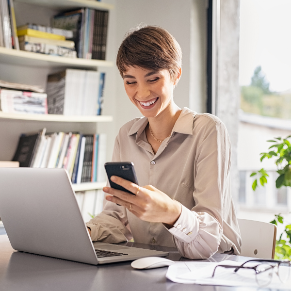 lady looking at her phone in an office background